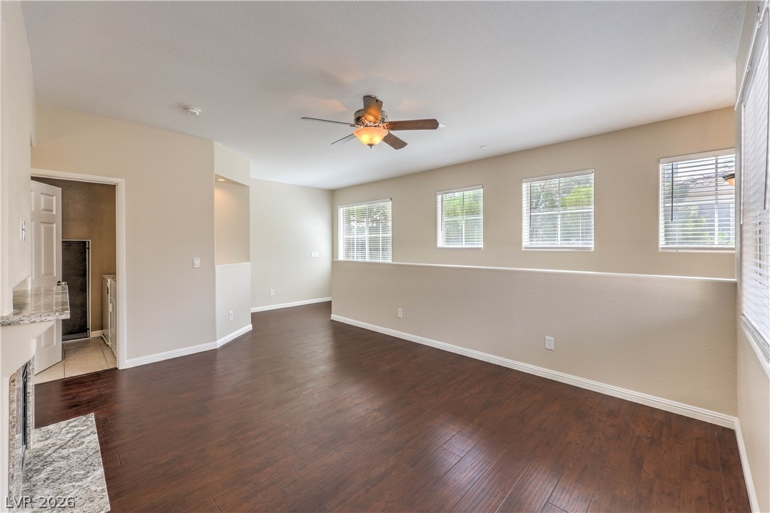 9050 West Warm Springs Road, Unit 2033 Las Vegas, NV 89148 - Photo 6 of 30 Rich hardwood flooring complements a practical layout, complete with a ceiling fan for comfort.
