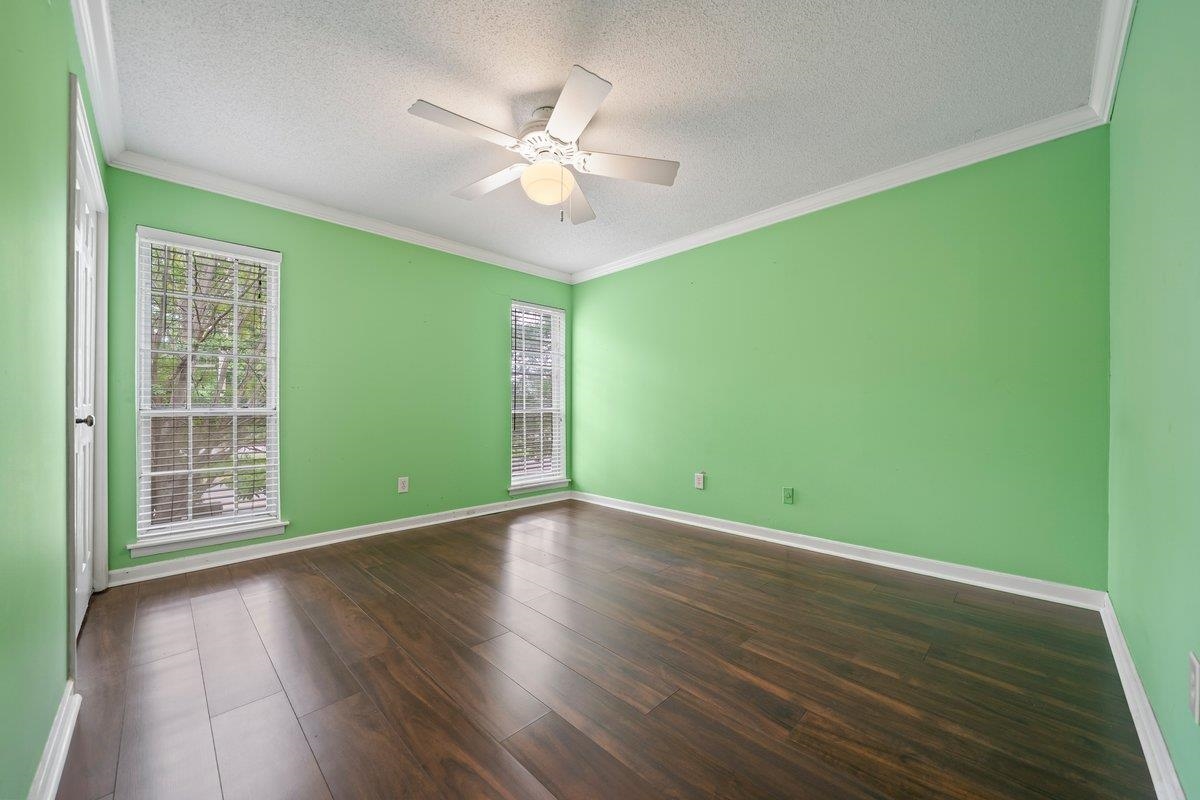 6942 Amberly Road, Unit 6942 Memphis, TN 38119 - Photo 17 of 23 a view of an empty room with wooden floor and a window