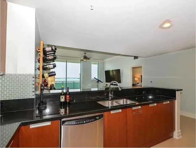 a kitchen with granite countertop a sink and a counter top space