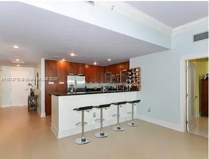 a kitchen with stainless steel appliances granite countertop a sink and a refrigerator