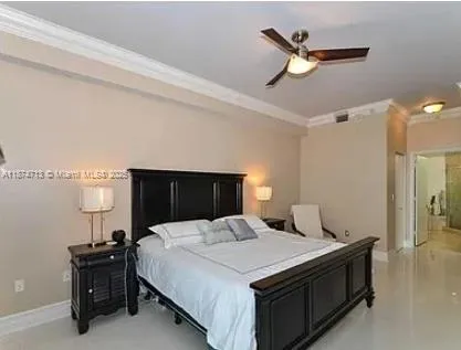 a bedroom with a bed and a ceiling fan