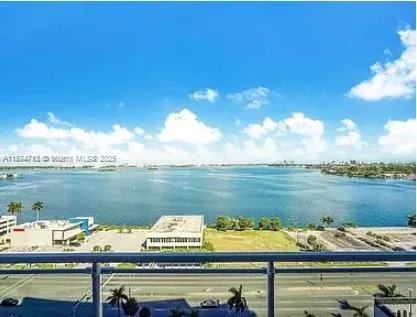 a view of a lake with couches chairs