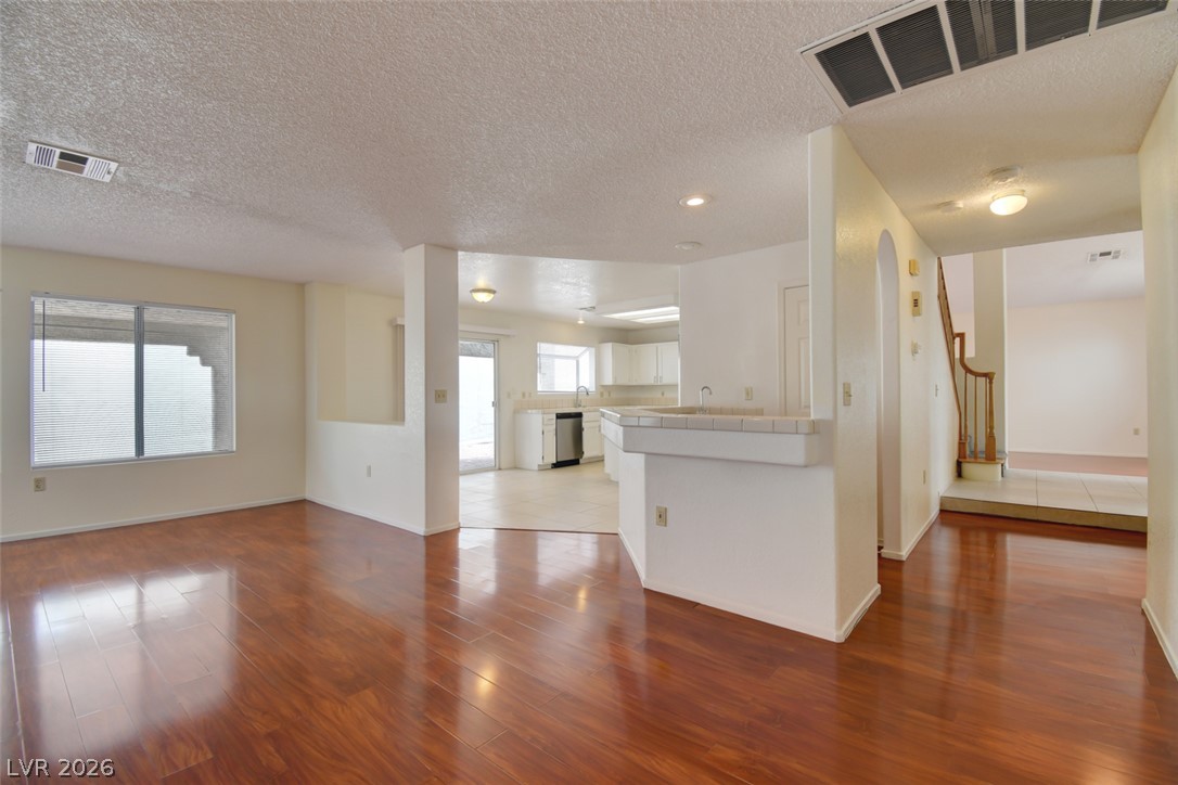 5 Tarryall Terrace Henderson, NV 89074 - Photo 15 of 44 Rich hardwood flooring creates a seamless flow through this adaptable living space, connecting to a functional kitchen.
