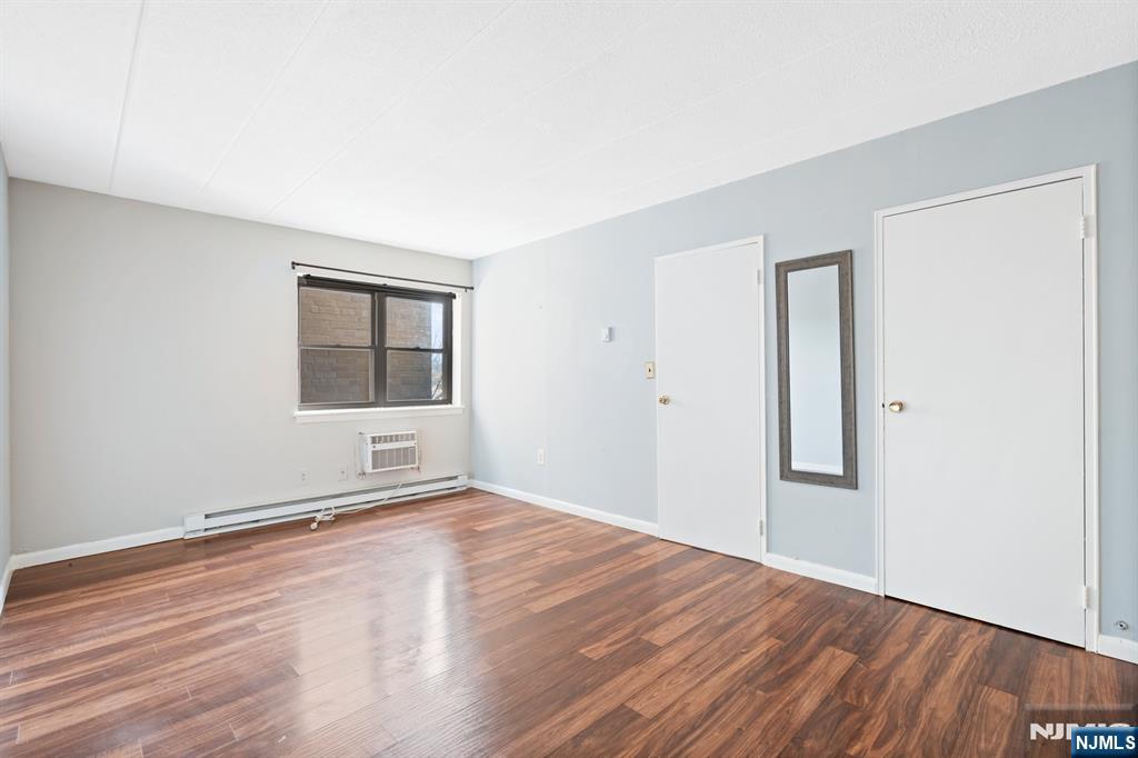 300 Lookout Avenue, Unit C4 Hackensack, NJ 07601 - Photo 15 of 18 an empty room with wooden floor and windows