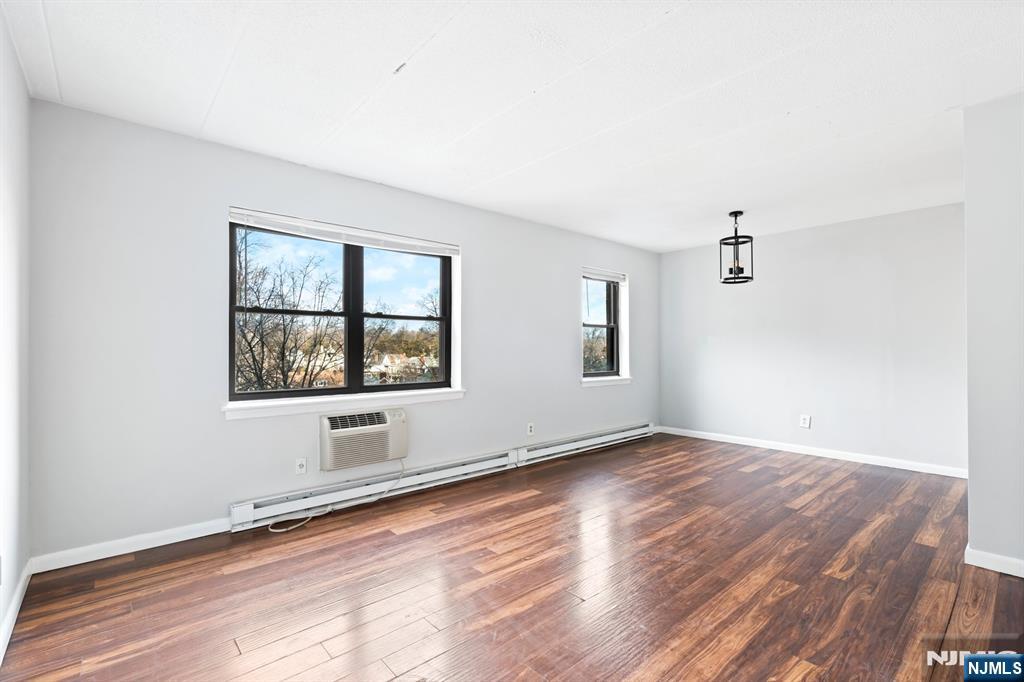 300 Lookout Avenue, Unit C4 Hackensack, NJ 07601 - Photo 6 of 18 an empty room with wooden floor and windows