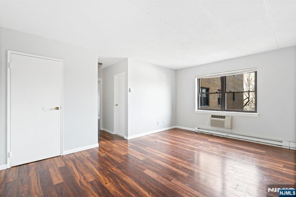 300 Lookout Avenue, Unit C4 Hackensack, NJ 07601 - Photo 7 of 18 a view of an empty room with window and wooden floor