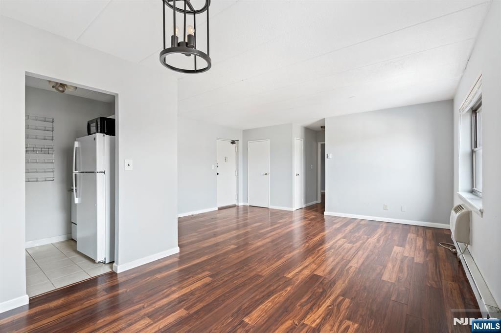 300 Lookout Avenue, Unit C4 Hackensack, NJ 07601 - Photo 9 of 18 a view of empty room with wooden floor and fan