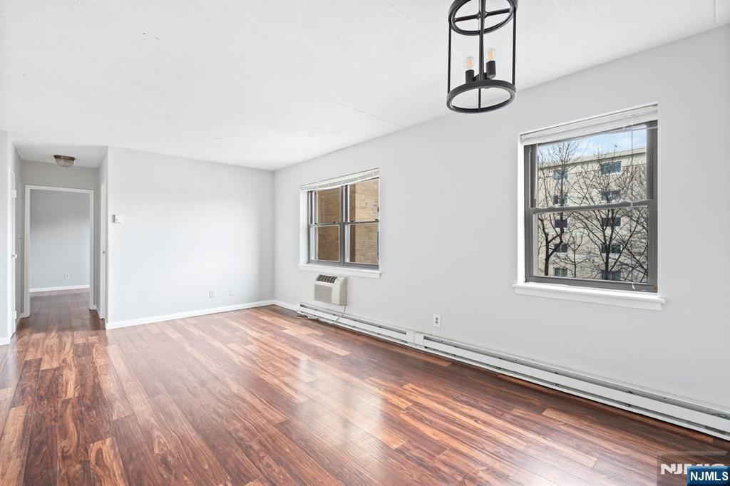 300 Lookout Avenue, Unit C4 Hackensack, NJ 07601 - Photo 10 of 18 a view of empty room with wooden floor and fan