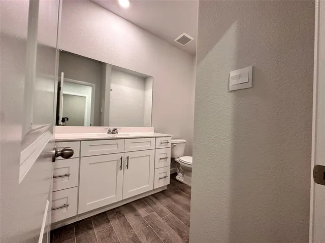 a spacious bathroom with a double vanity sink and a mirror