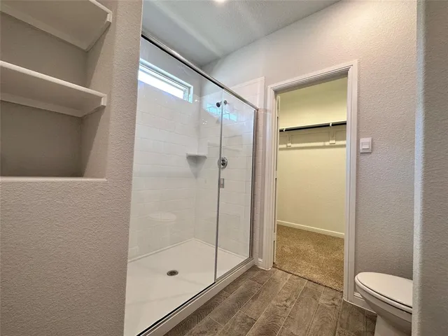 a bathroom with a shower and a toilet