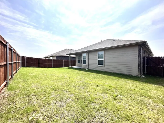 a balcony with table and chairs