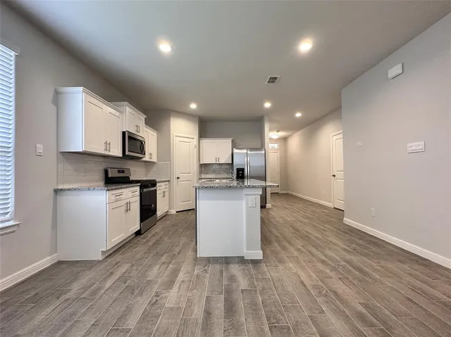 a kitchen with a refrigerator and a microwave
