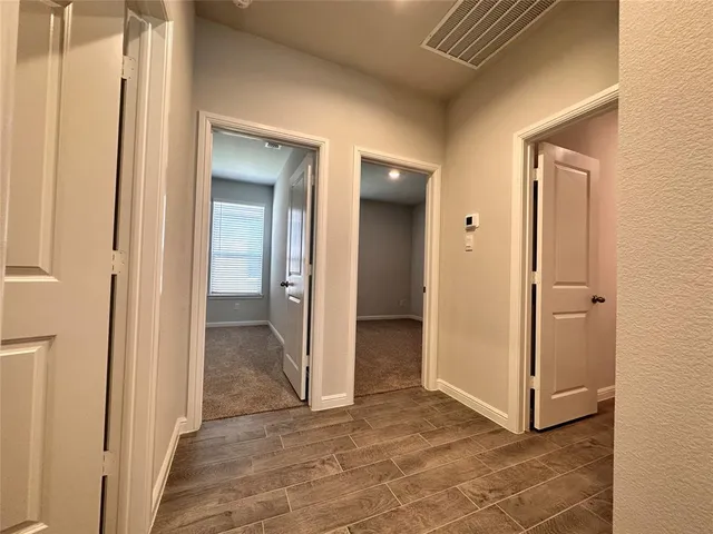 a view of a hallway with wooden shelves