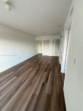 a view of bedroom and bedroom with wooden floor