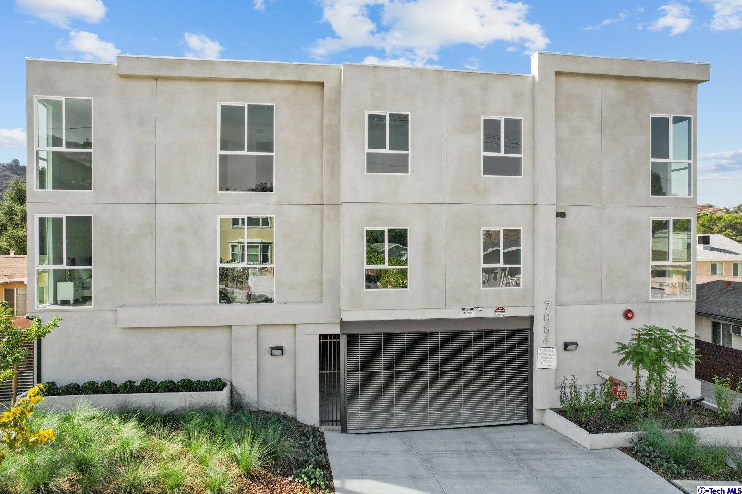 7064 Greeley Street, Unit 102 Tujunga, CA 91042 - Photo 2 of 27 front view of a house with a garden