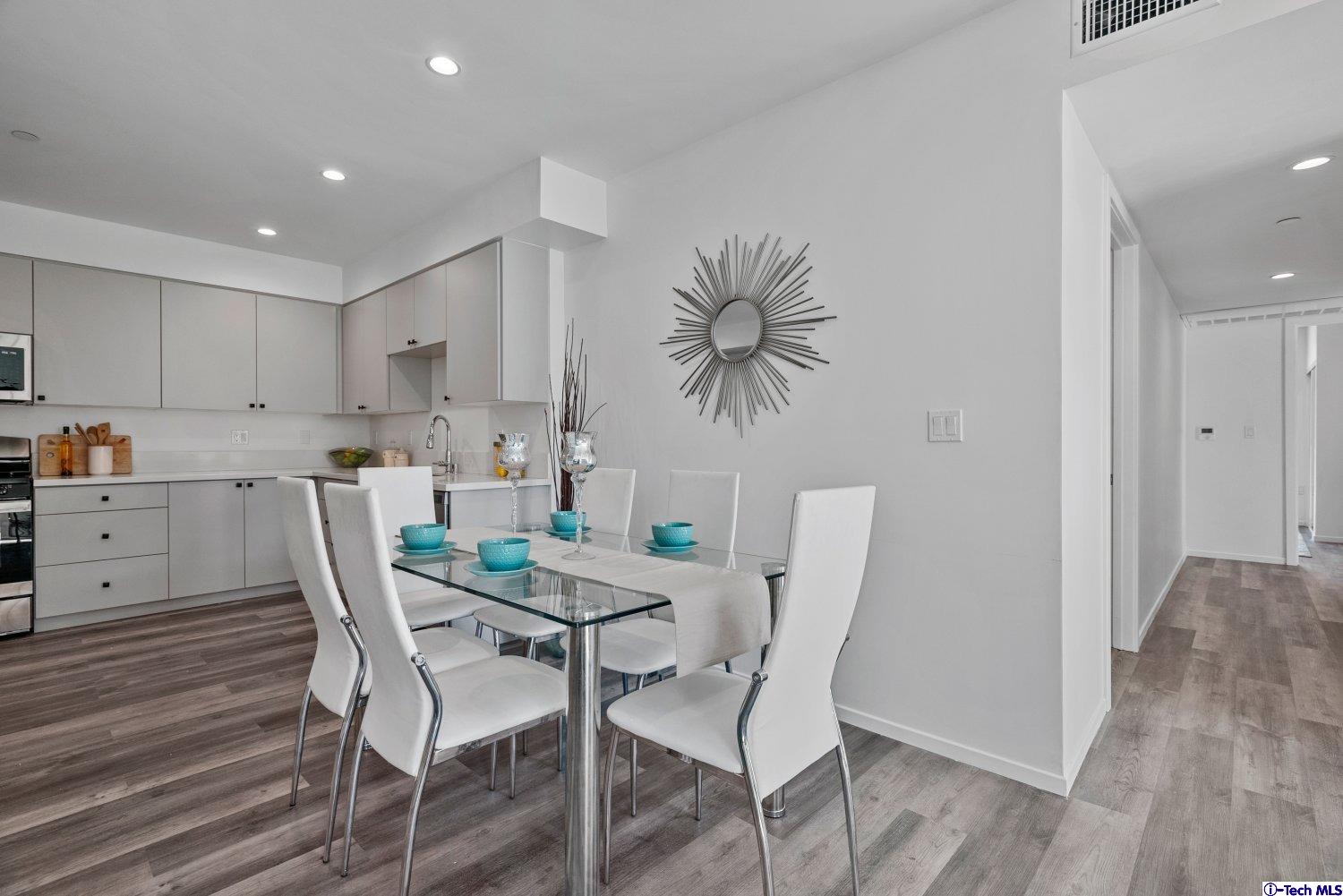 7064 Greeley Street, Unit 102 Tujunga, CA 91042 - Photo 11 of 27 a view of a dining room with furniture and wooden floor