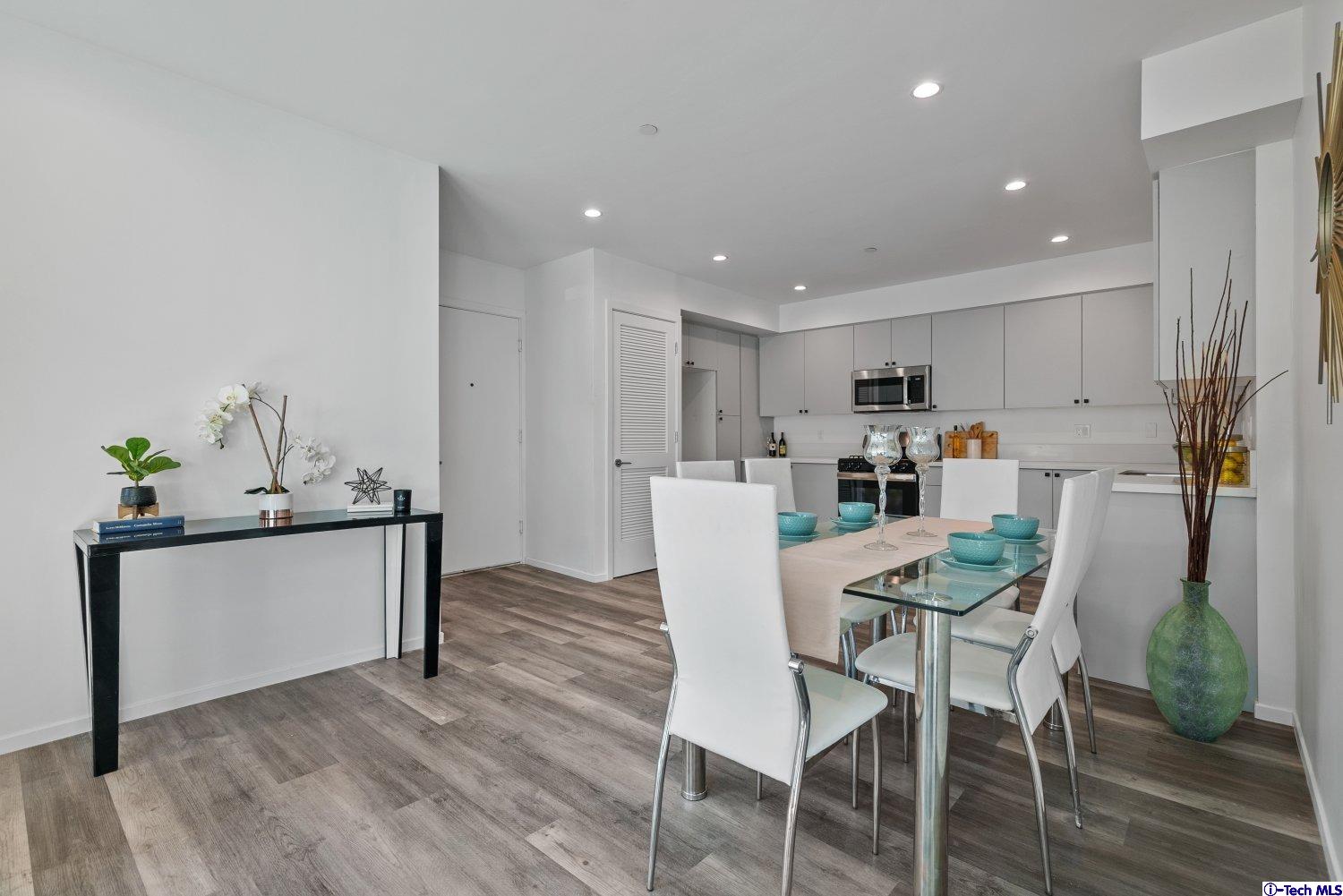 7064 Greeley Street, Unit 102 Tujunga, CA 91042 - Photo 12 of 27 a view of a dining room with furniture and wooden floor