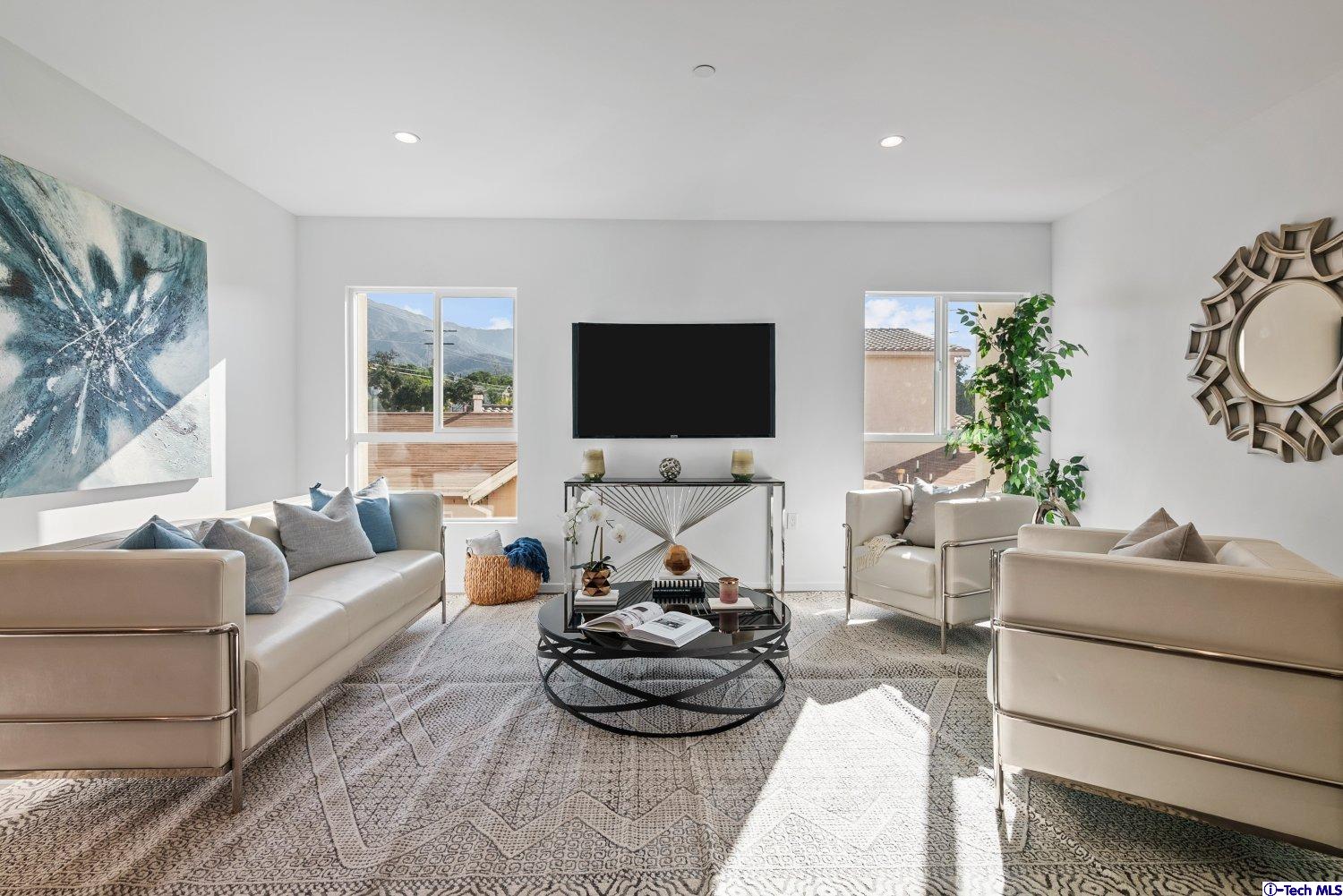 7064 Greeley Street, Unit 102 Tujunga, CA 91042 - Photo 13 of 27 a living room with furniture and a flat screen tv