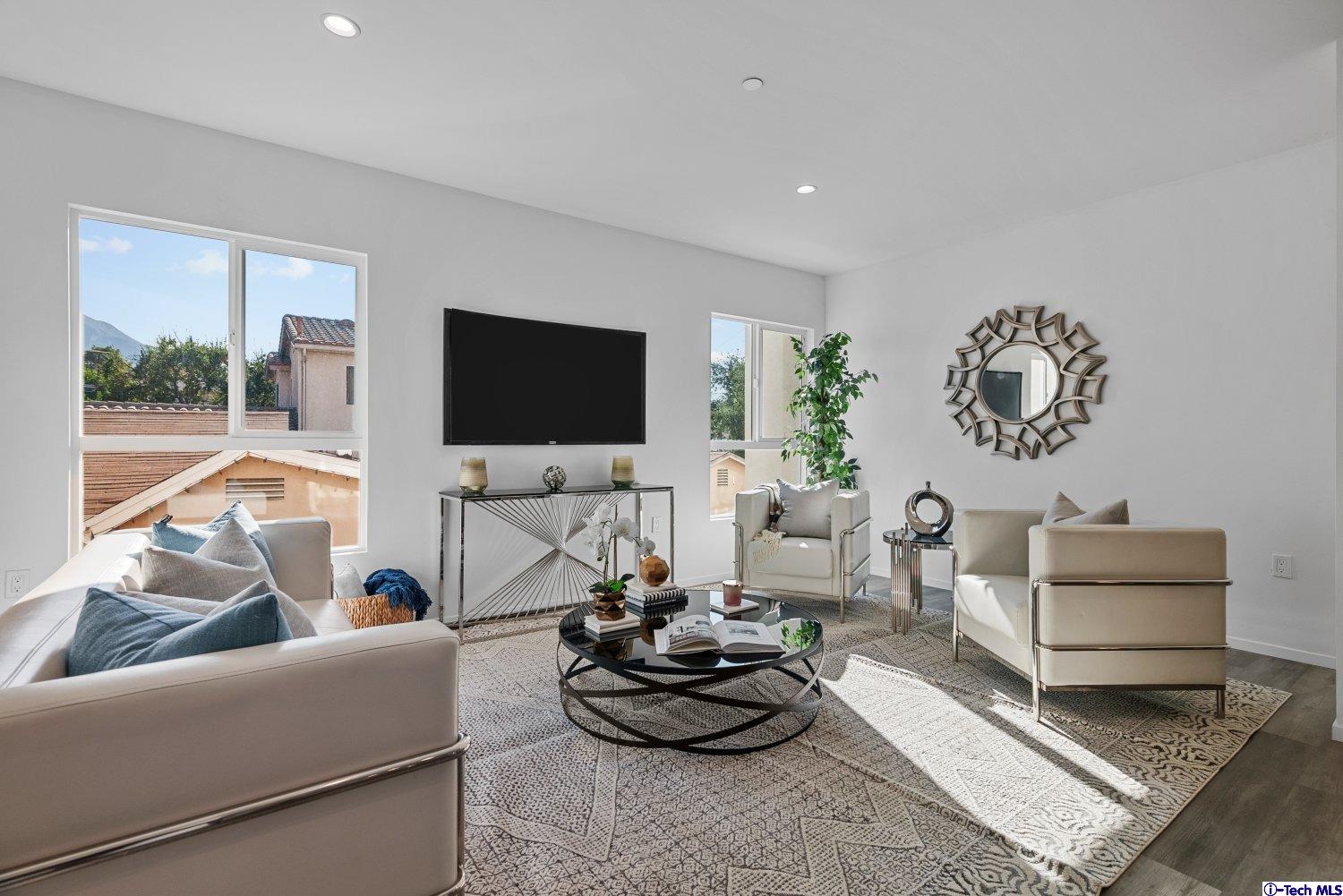 7064 Greeley Street, Unit 102 Tujunga, CA 91042 - Photo 14 of 27 a living room with furniture and a flat screen tv
