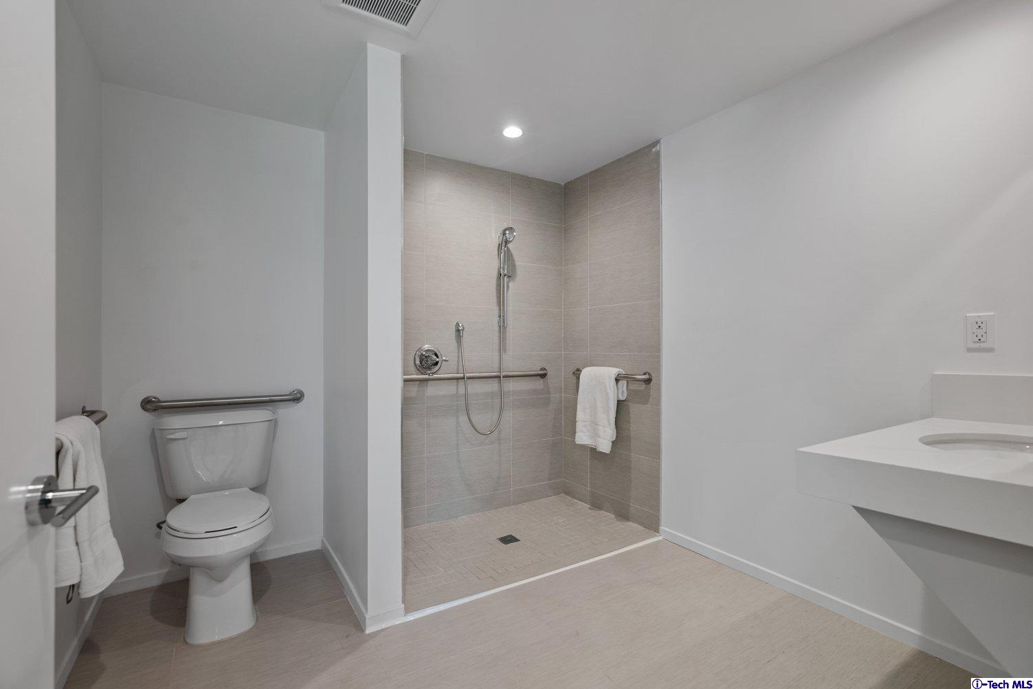 7064 Greeley Street, Unit 102 Tujunga, CA 91042 - Photo 15 of 27 a bathroom with a toilet sink and shower