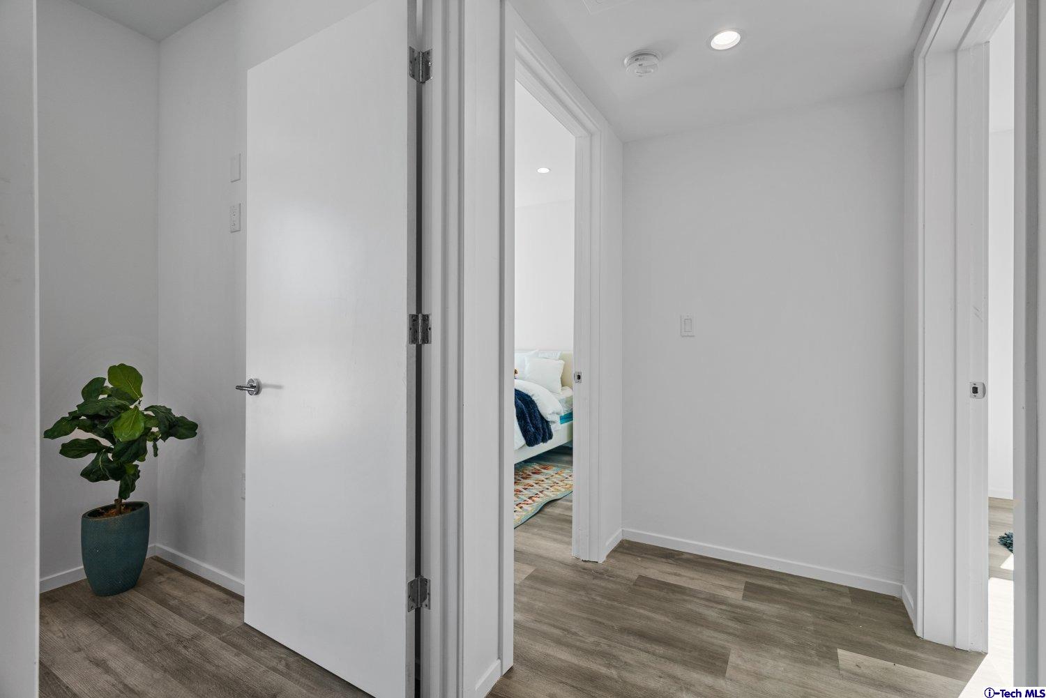7064 Greeley Street, Unit 102 Tujunga, CA 91042 - Photo 16 of 27 a view of a hallway with wooden floor and livingroom