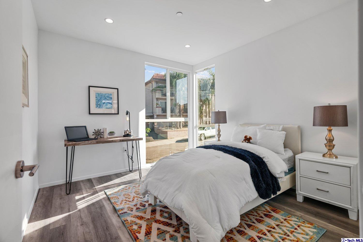 7064 Greeley Street, Unit 102 Tujunga, CA 91042 - Photo 19 of 27 a bedroom with a bed and wooden floor