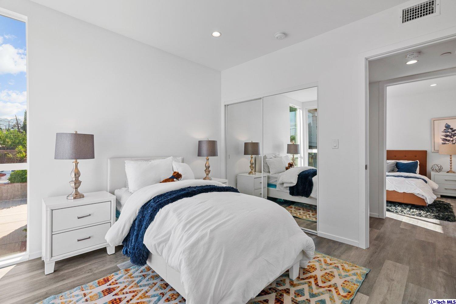 7064 Greeley Street, Unit 102 Tujunga, CA 91042 - Photo 20 of 27 a bedroom with bed and wooden floor