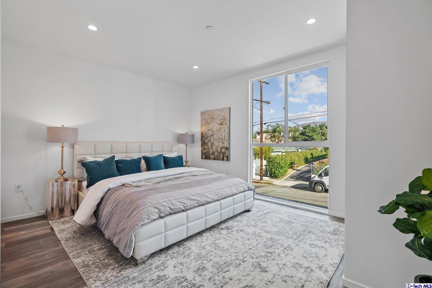 7064 Greeley Street, Unit 102 Tujunga, CA 91042 - Photo 21 of 27 a bedroom with a large bed and a window