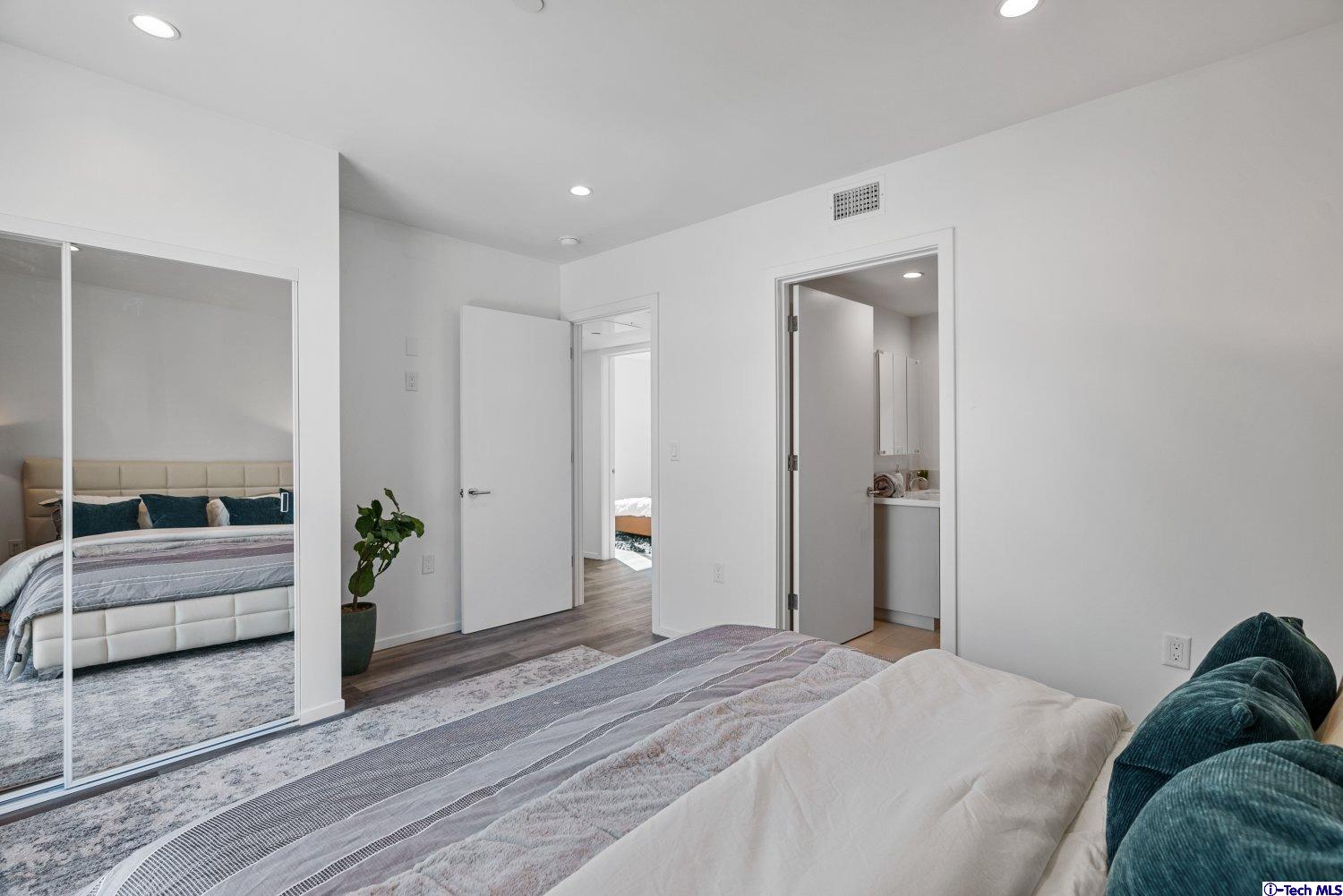 7064 Greeley Street, Unit 102 Tujunga, CA 91042 - Photo 22 of 27 a bedroom with a bed and a couch