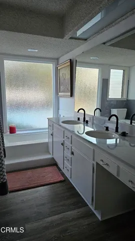 a bathroom with a double vanity sink and mirror