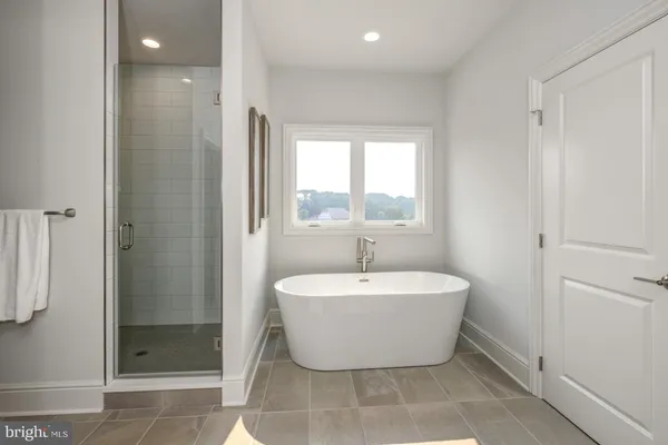 a bathroom with a bathtub and shower