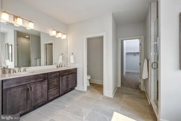 a spacious bathroom with a granite countertop sink and a mirror