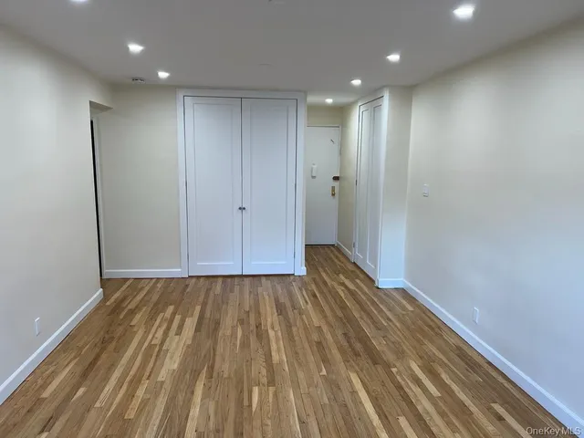 a view of hallway with wooden floor