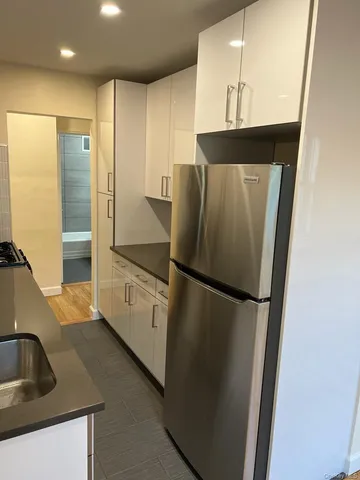 a kitchen with stainless steel appliances a refrigerator and a sink