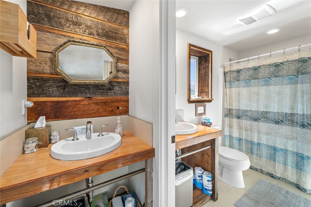 6790 West Pozo Road Santa Margarita, CA 93453 - Photo 26 of 68 a bathroom with a sink toilet a mirror and vanity