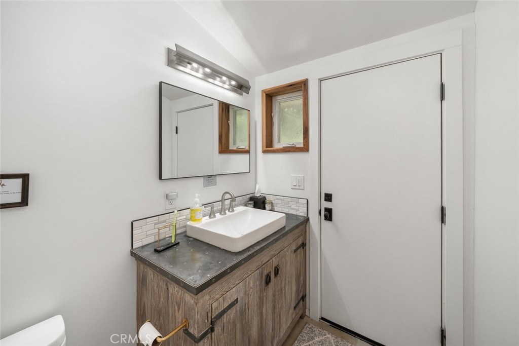 6790 West Pozo Road Santa Margarita, CA 93453 - Photo 35 of 64 a bathroom with a sink toilet and mirror