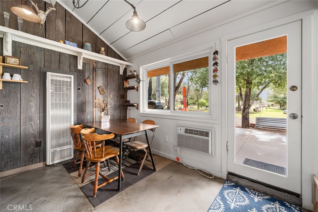 6790 West Pozo Road Santa Margarita, CA 93453 - Photo 54 of 68 a dining room with furniture a floor to ceiling window and wooden floor