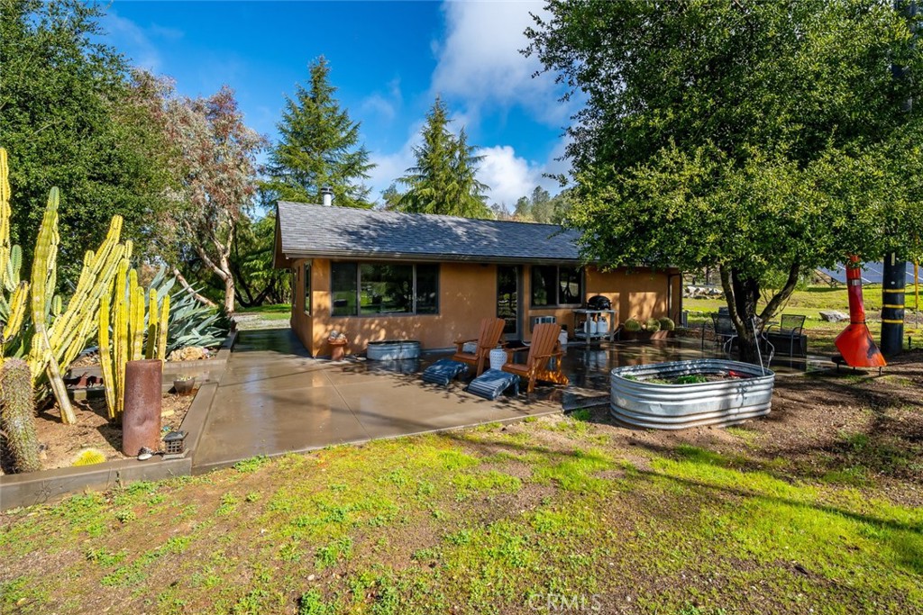 6790 West Pozo Road Santa Margarita, CA 93453 - Photo 8 of 68 a view of a patio with table and chairs potted plants and large tree