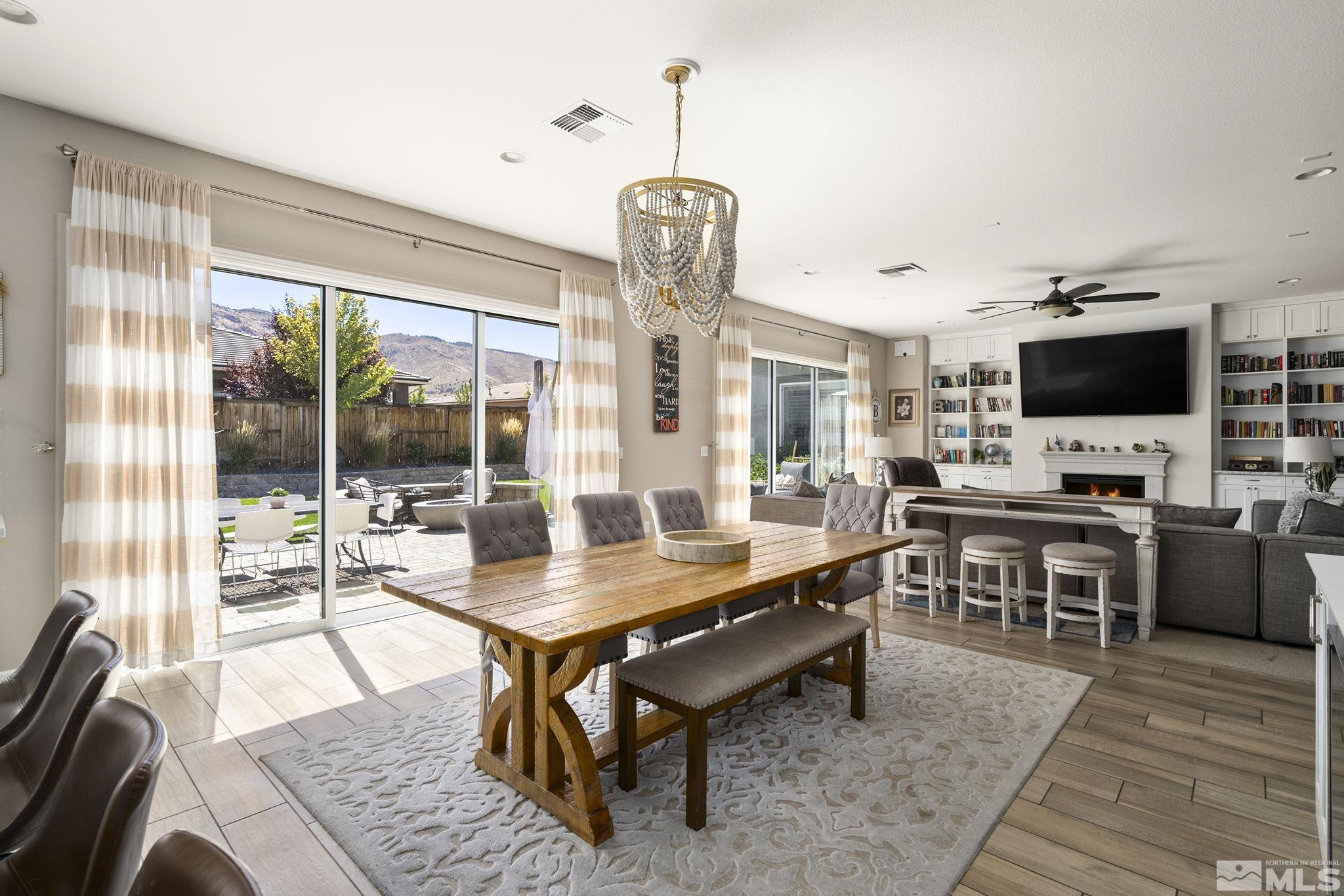 9820 Firefoot Lane Reno, NV 89521 - Photo 11 of 40 a dining room with wooden floor and a chandelier
