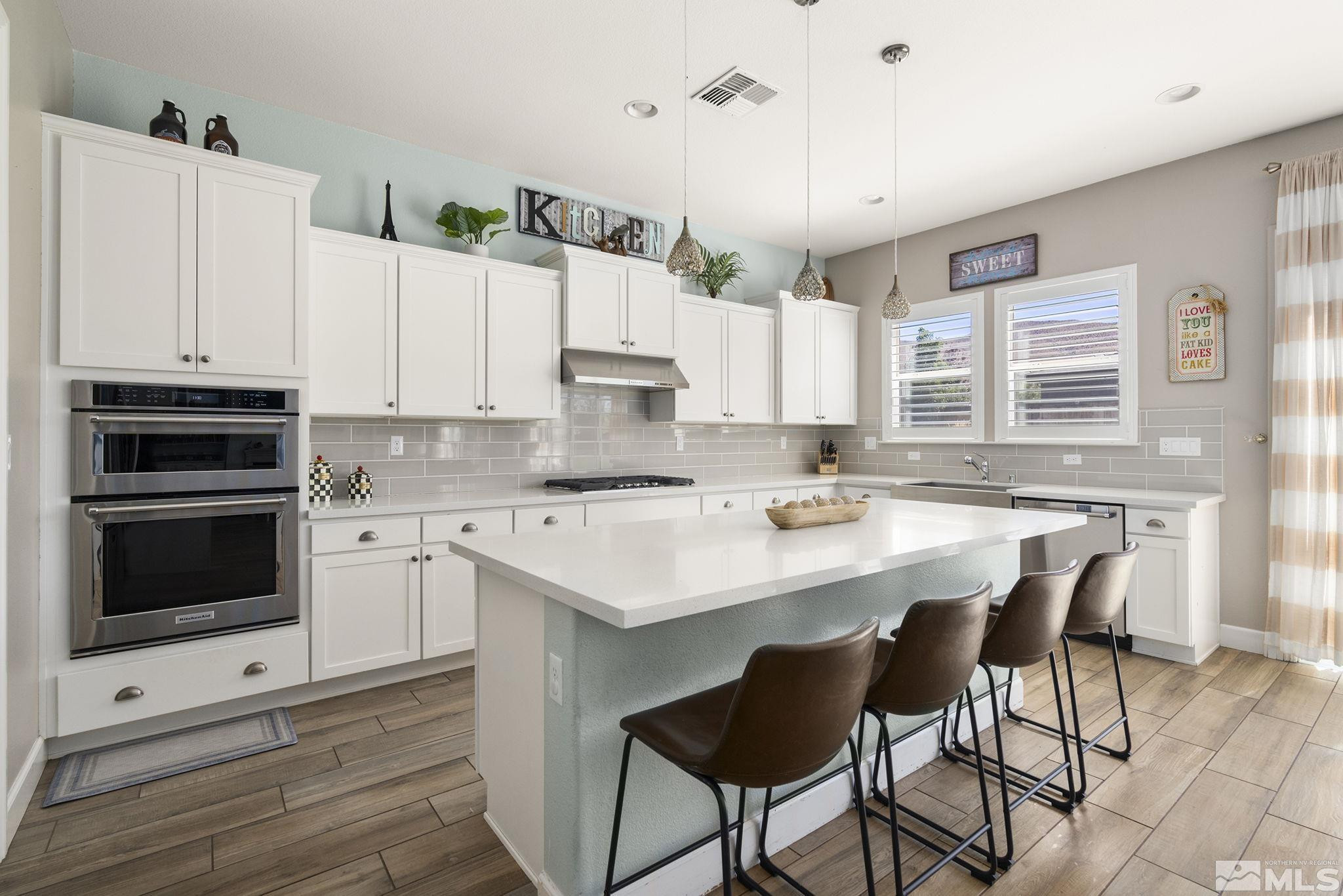 9820 Firefoot Lane Reno, NV 89521 - Photo 12 of 40 a kitchen with a sink stove and white cabinets