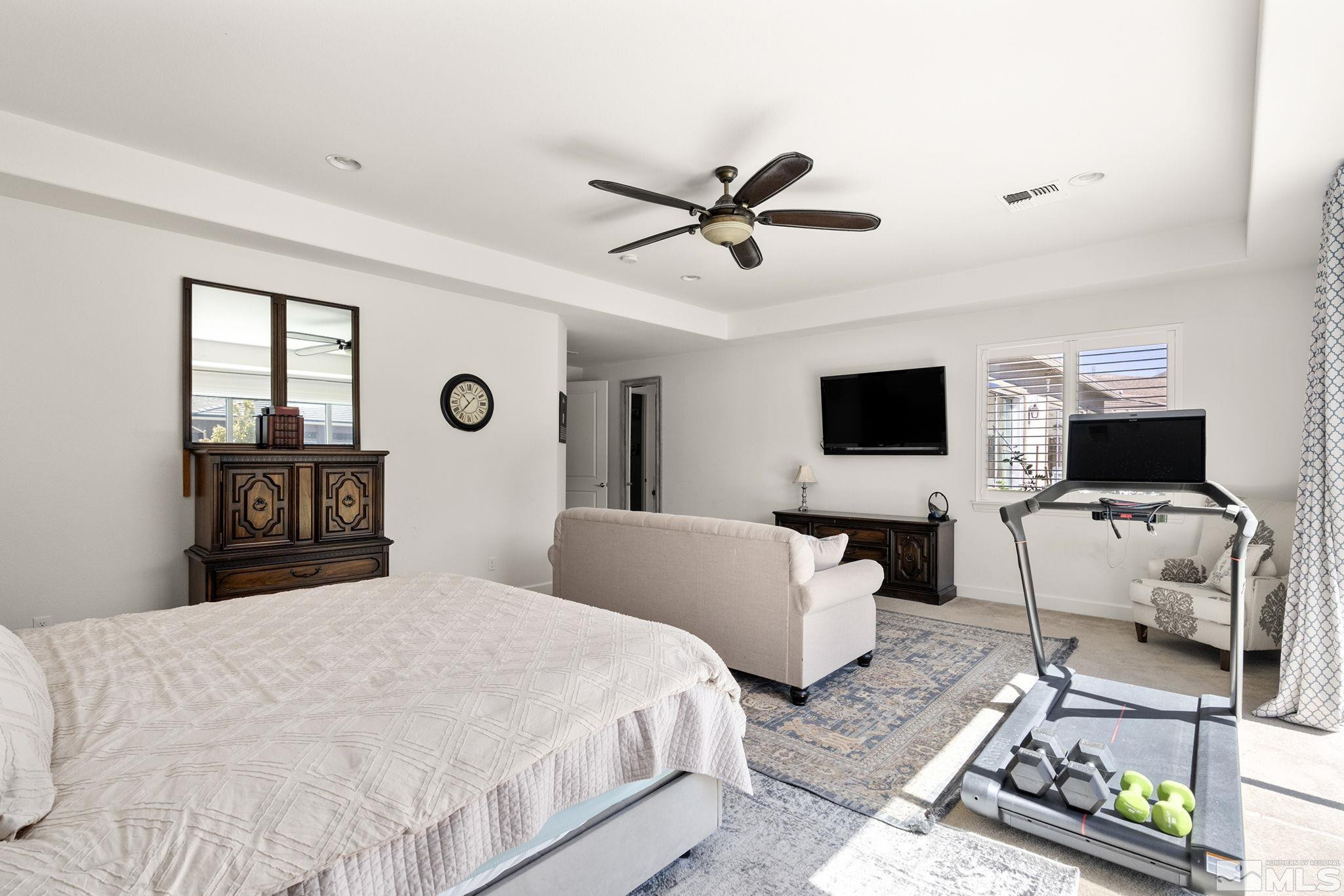 9820 Firefoot Lane Reno, NV 89521 - Photo 16 of 40 a bedroom with a bed and a flat screen tv