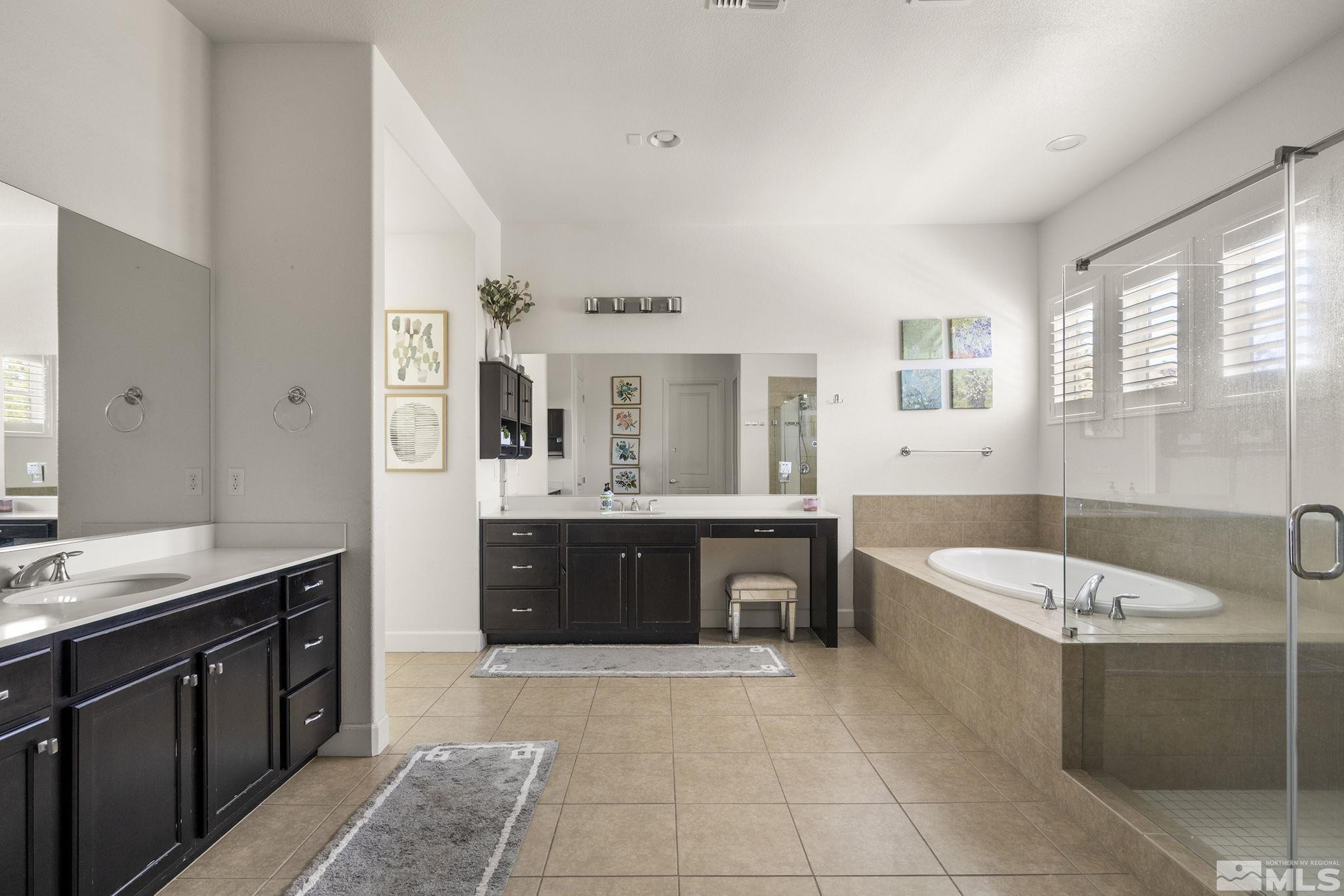 9820 Firefoot Lane Reno, NV 89521 - Photo 17 of 40 a spacious bathroom with a tub sink shower and mirror
