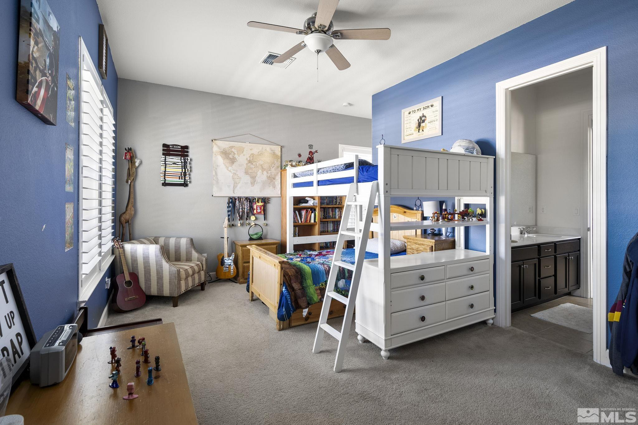9820 Firefoot Lane Reno, NV 89521 - Photo 21 of 40 a bedroom with furniture and a lamp