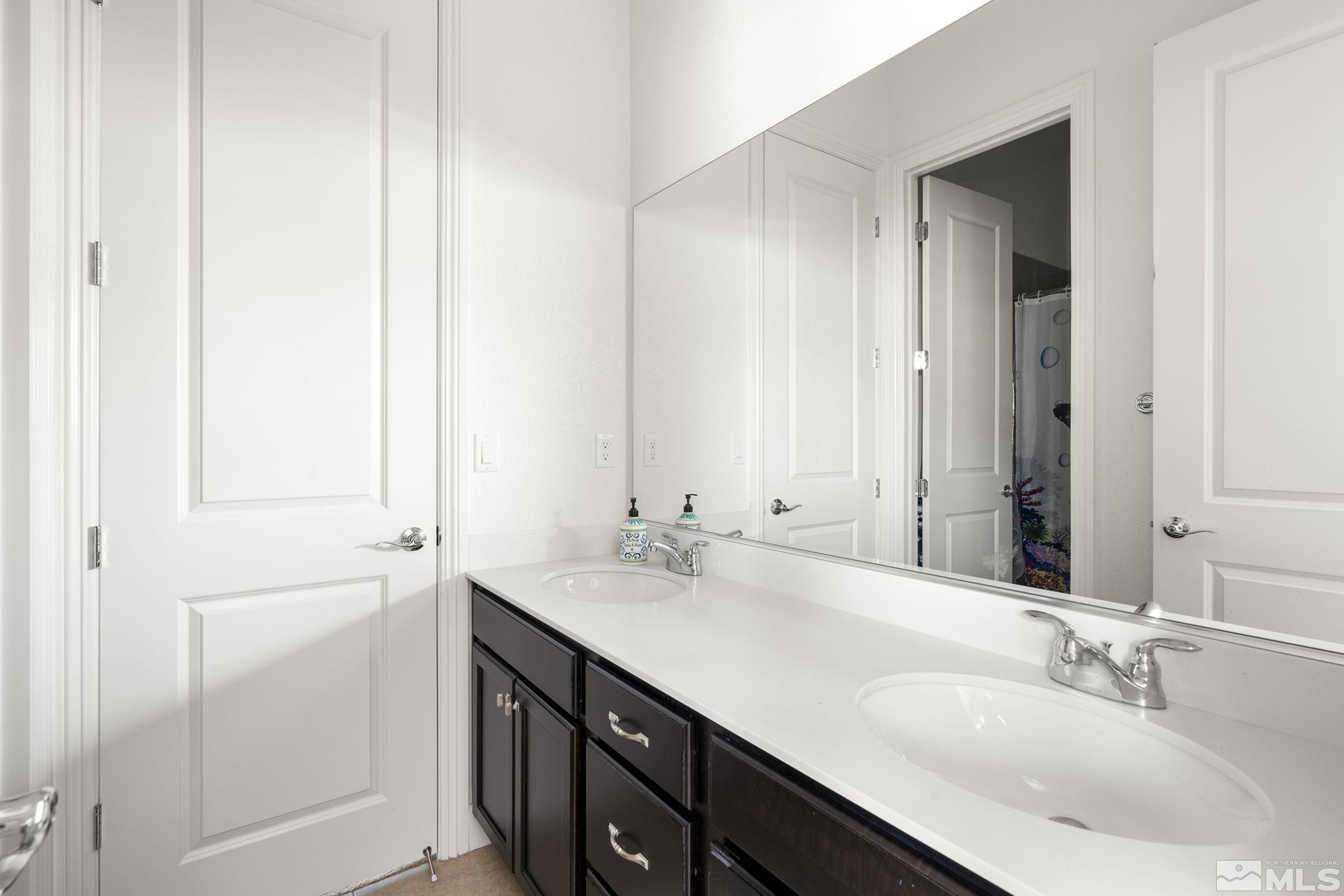 9820 Firefoot Lane Reno, NV 89521 - Photo 22 of 40 a bathroom with a sink and a mirror