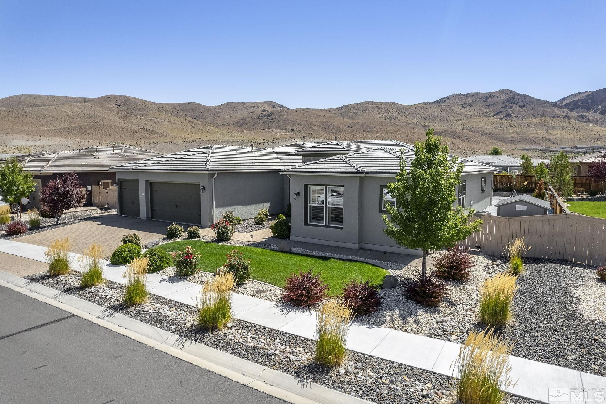 9820 Firefoot Lane Reno, NV 89521 - Photo 29 of 40 a front view of a house with a yard table and chairs