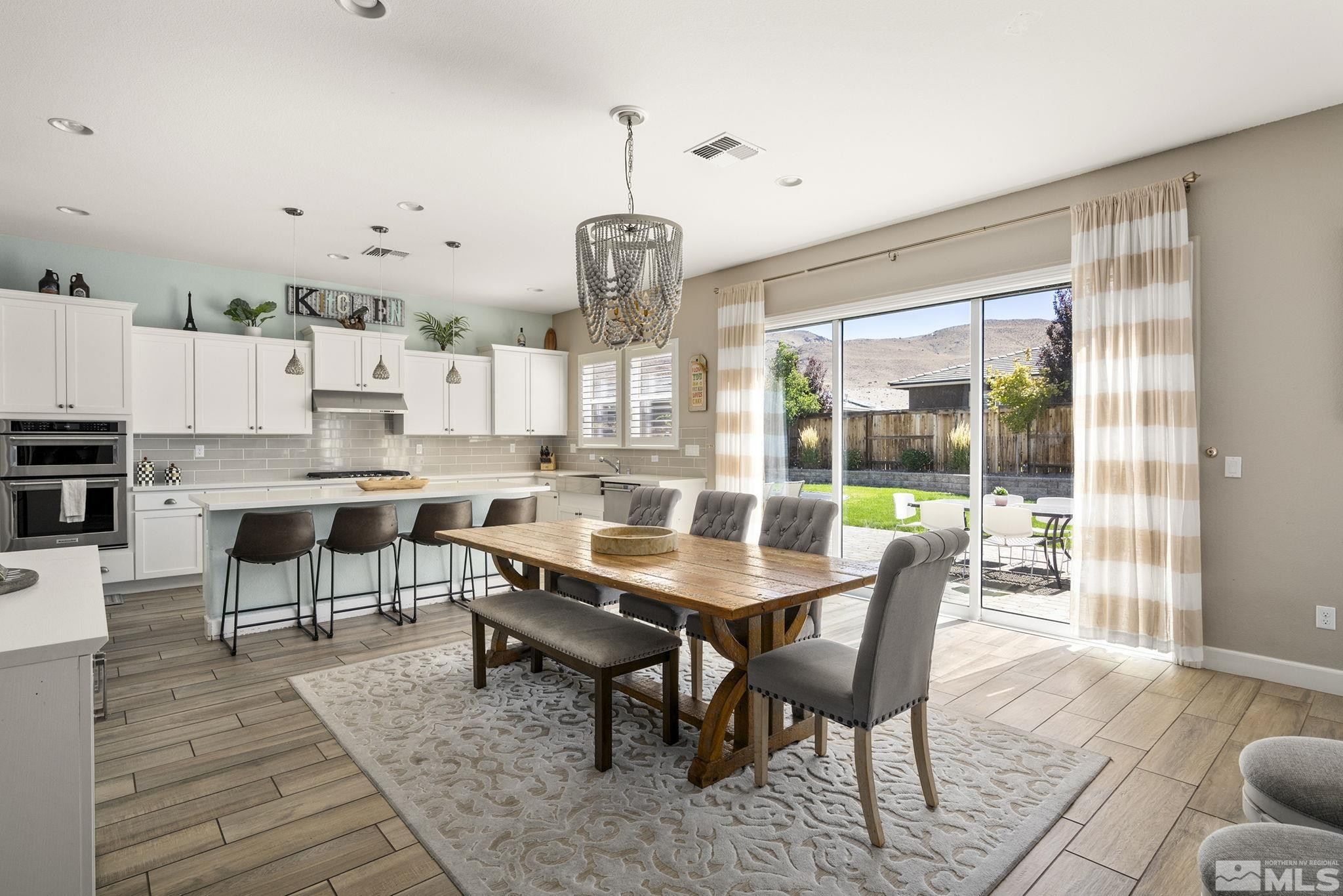 9820 Firefoot Lane Reno, NV 89521 - Photo 9 of 40 a dining room with furniture a chandelier and wooden floor