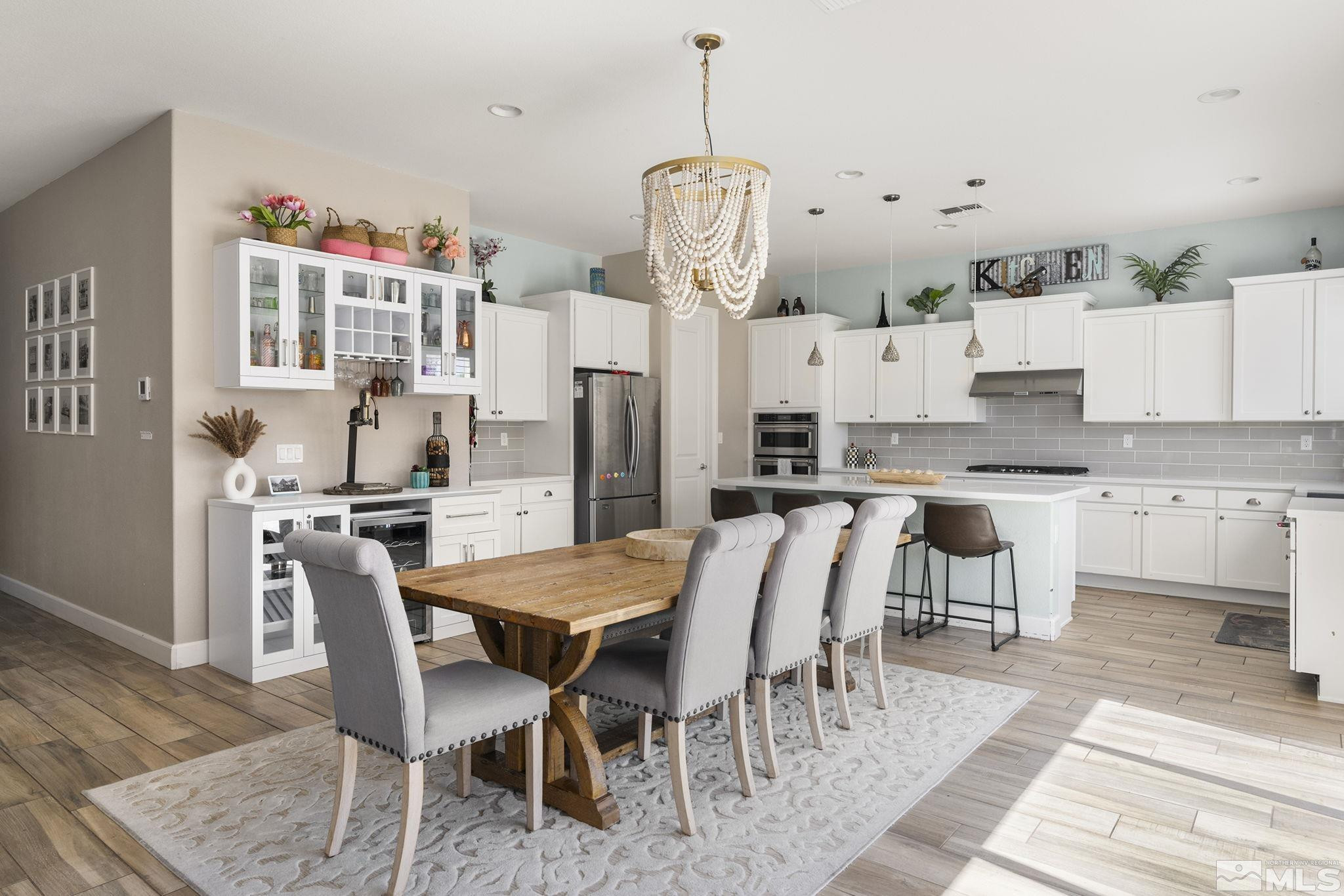 9820 Firefoot Lane Reno, NV 89521 - Photo 10 of 40 a kitchen with stainless steel appliances kitchen island granite countertop a table chairs and a refrigerator