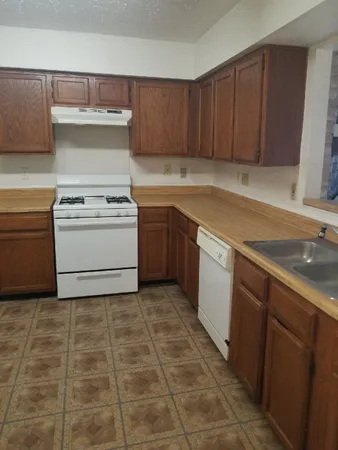 a kitchen with a cabinets and white appliances