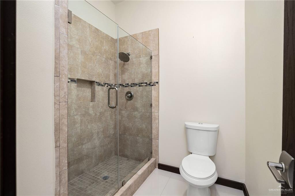 914 Rio Grande Drive Mission, TX 78572 - Photo 13 of 27 a white toilet sitting next to a bathroom sink