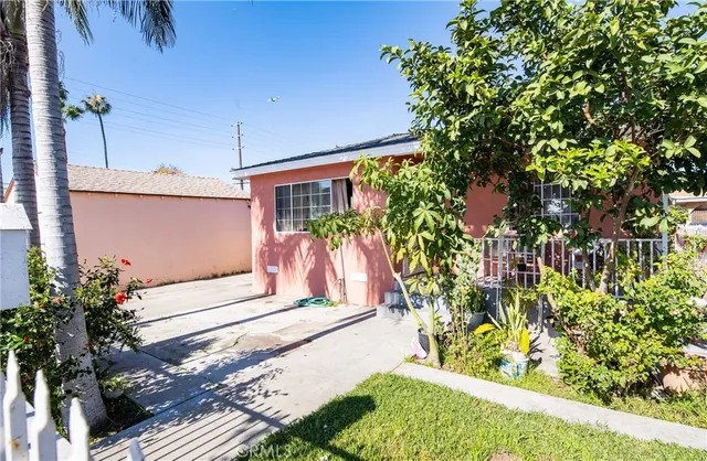 a front view of a house with a yard and flowers